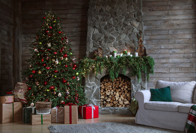 Photo of Festive interior with decorated Christmas tree and fireplace