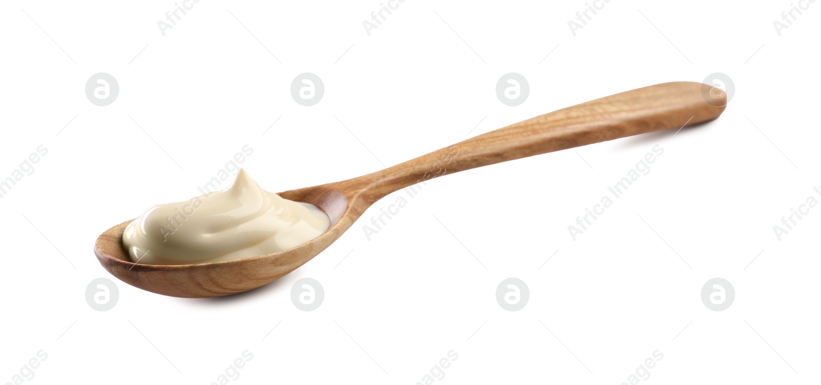 Photo of Natural yogurt in wooden spoon isolated on white