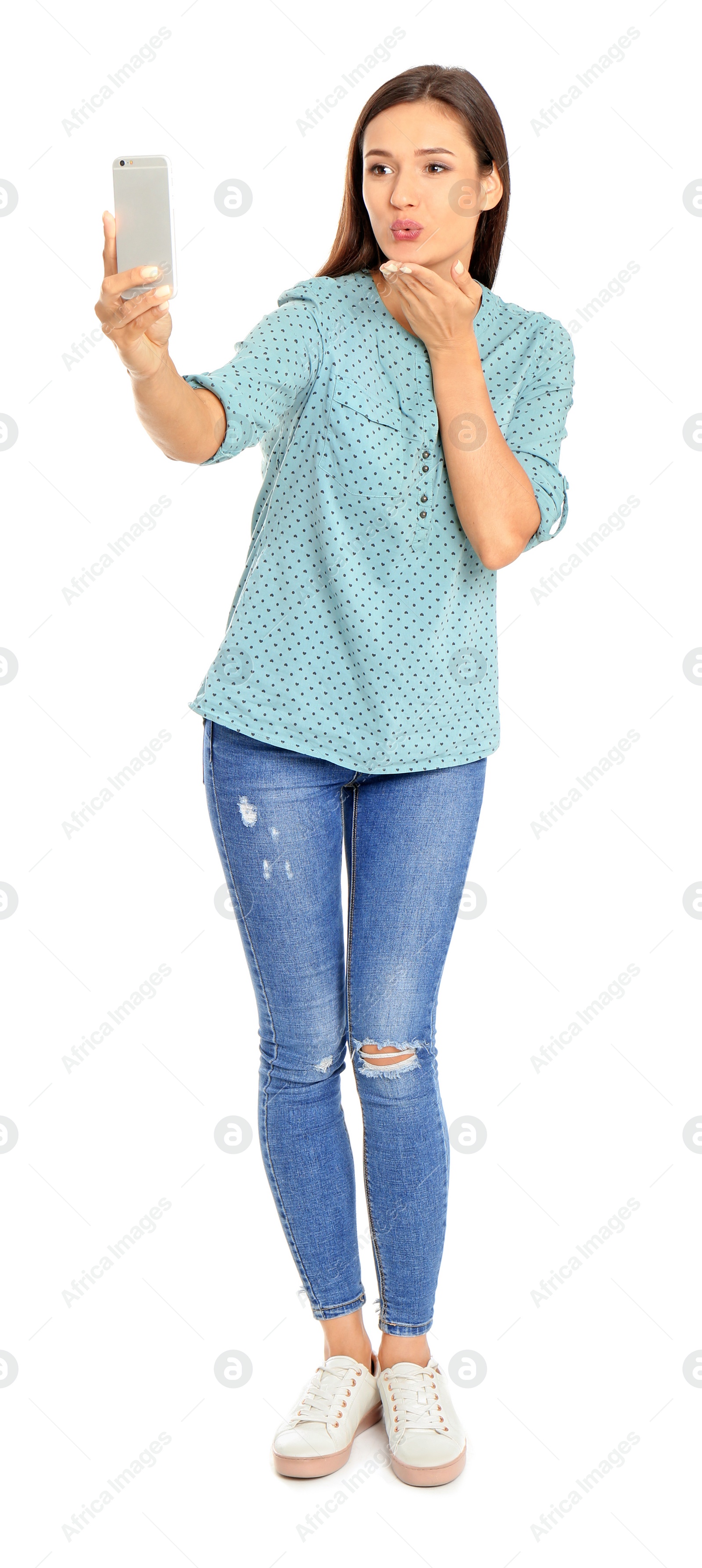 Photo of Young beautiful woman taking selfie against white background