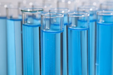 Photo of Test tubes with light blue reagents, closeup. Laboratory analysis