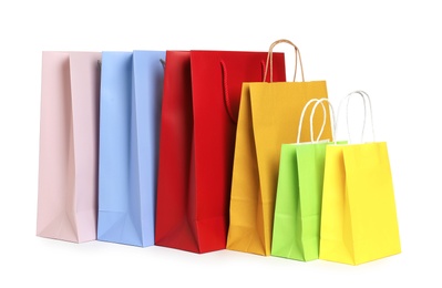 Photo of Colorful paper shopping bags on white background