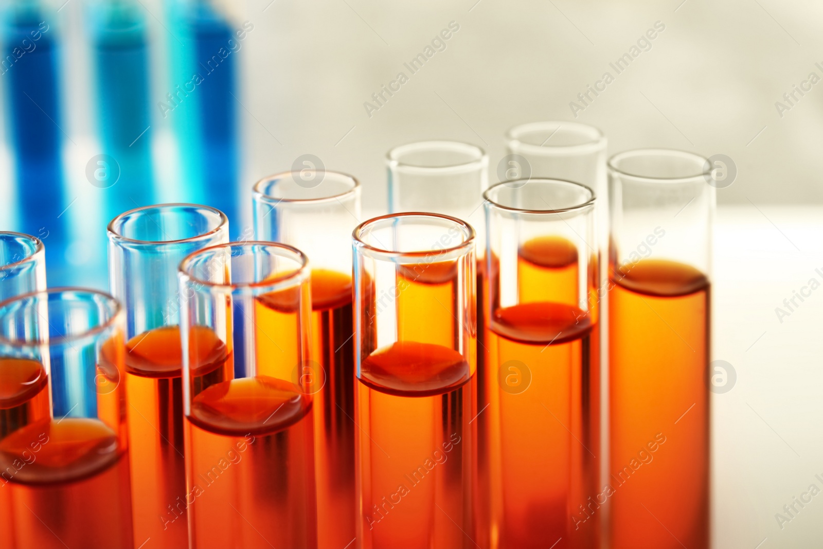 Photo of Closeup view of many test tubes with orange liquid, color tone effect