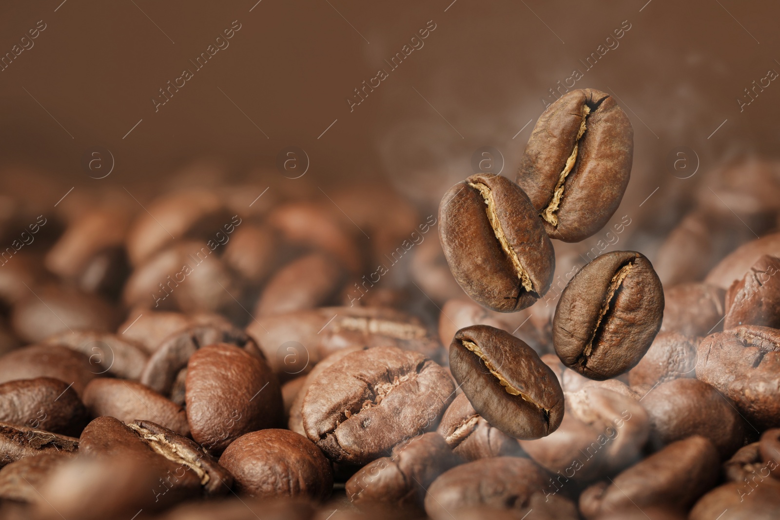 Image of Aromatic roasted coffee beans and steam, closeup