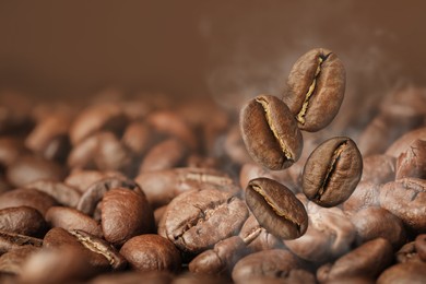 Image of Aromatic roasted coffee beans and steam, closeup