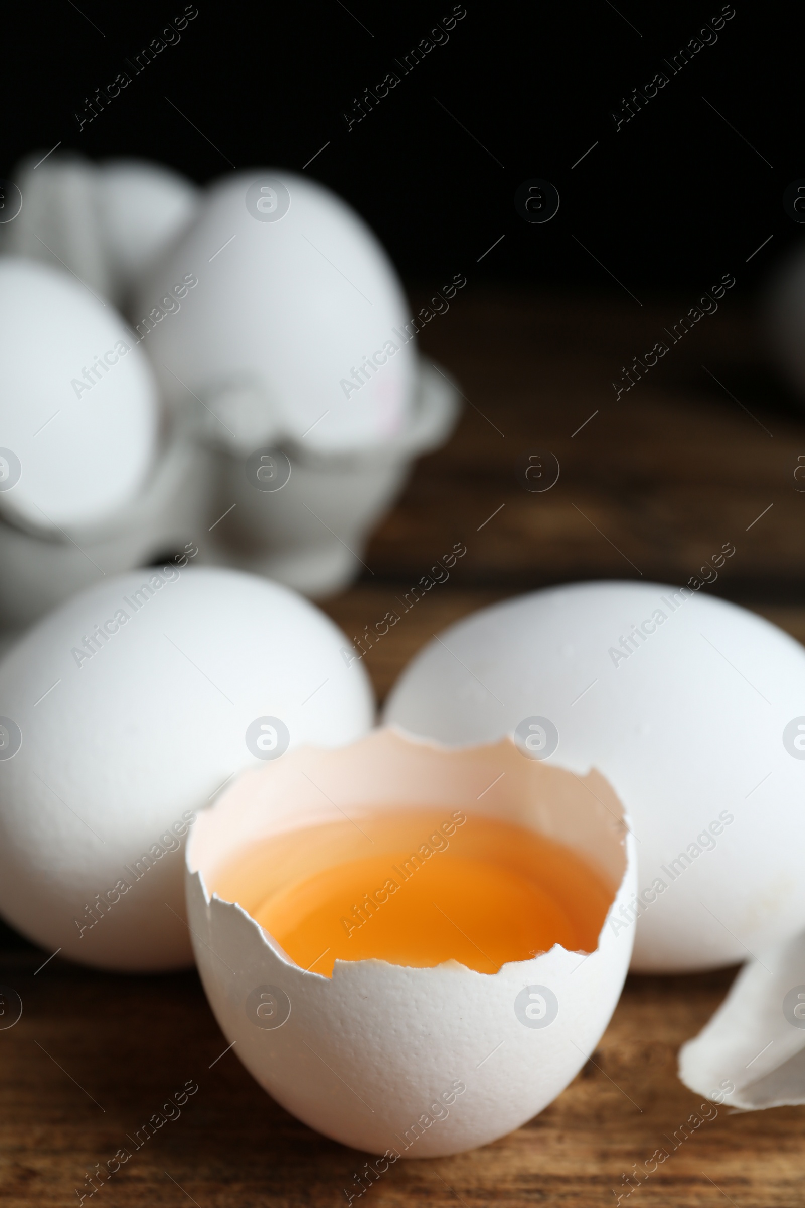 Photo of Fresh raw chicken eggs on wooden table, closeup