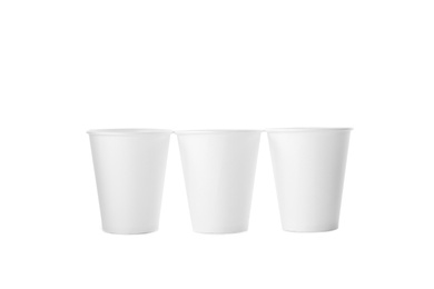 Photo of Empty disposable paper cups isolated on white