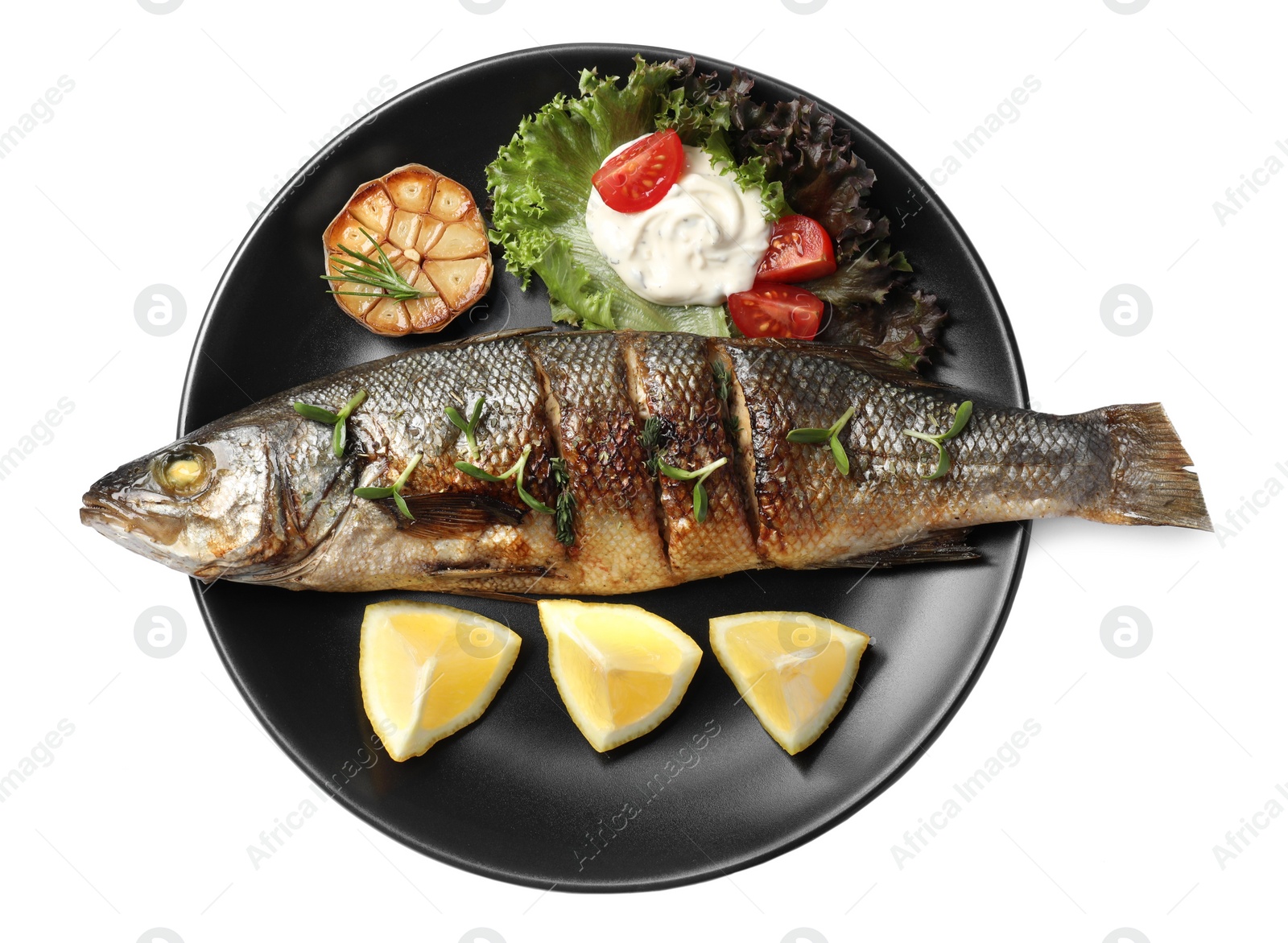 Photo of Plate with delicious sea bass fish and ingredients isolated on white, top view