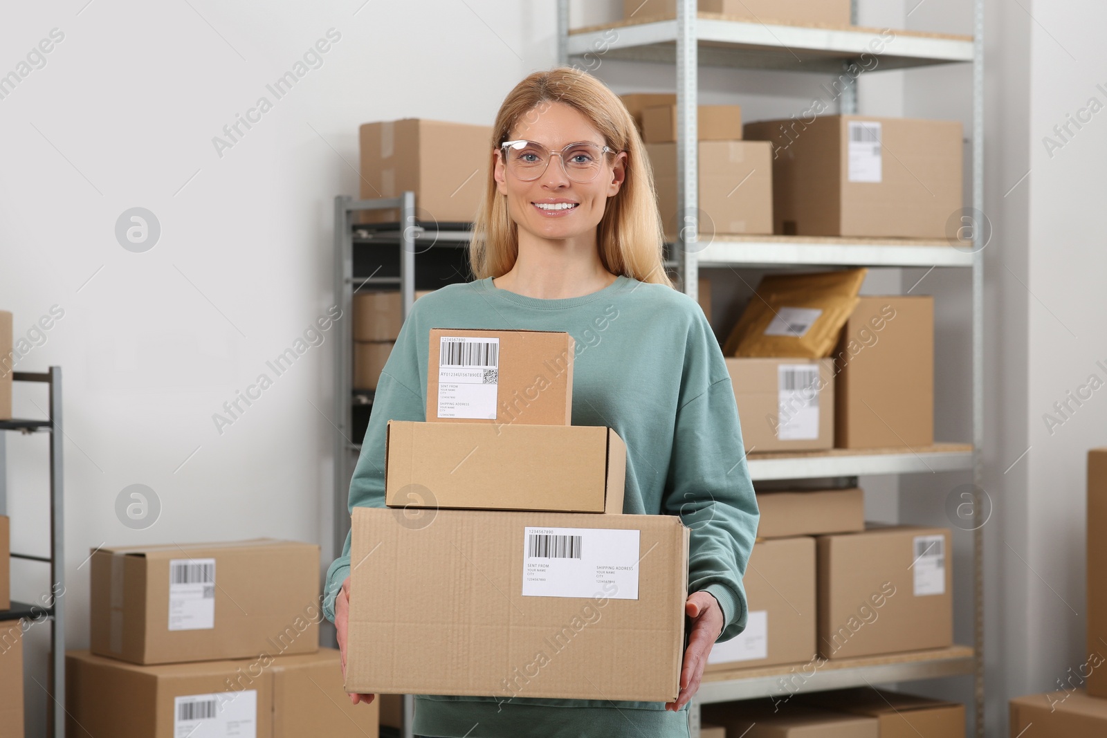 Photo of Seller with parcels in office. Online store