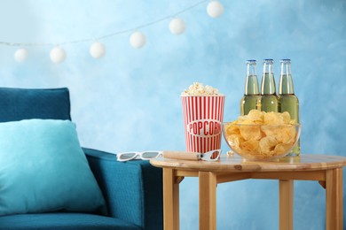 Photo of Beer, snacks and bottle opener on wooden table indoors, space for text. Party time