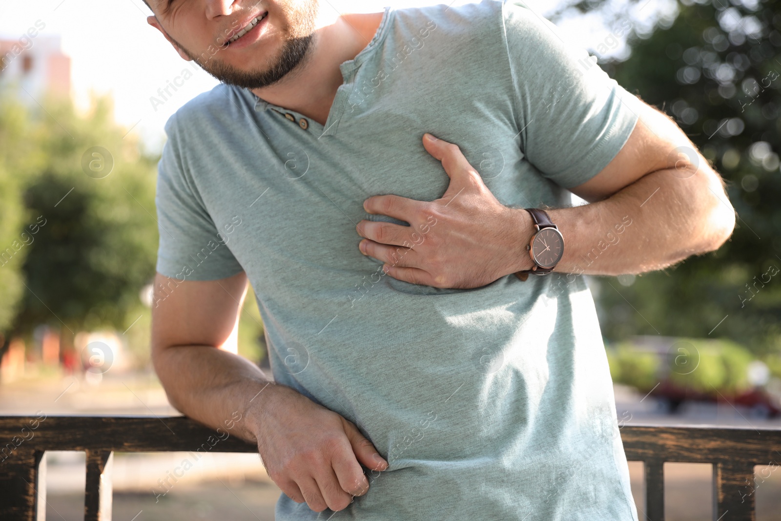 Photo of Man having heart attack outdoors, closeup view