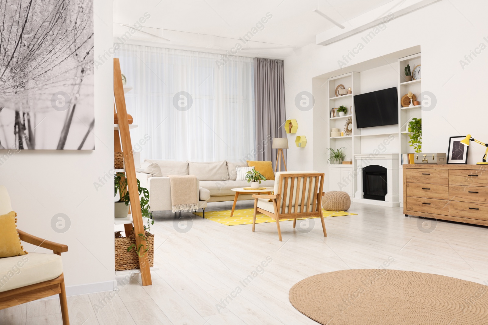 Photo of Spring atmosphere. Stylish room interior with cozy furniture in yellow and white colors