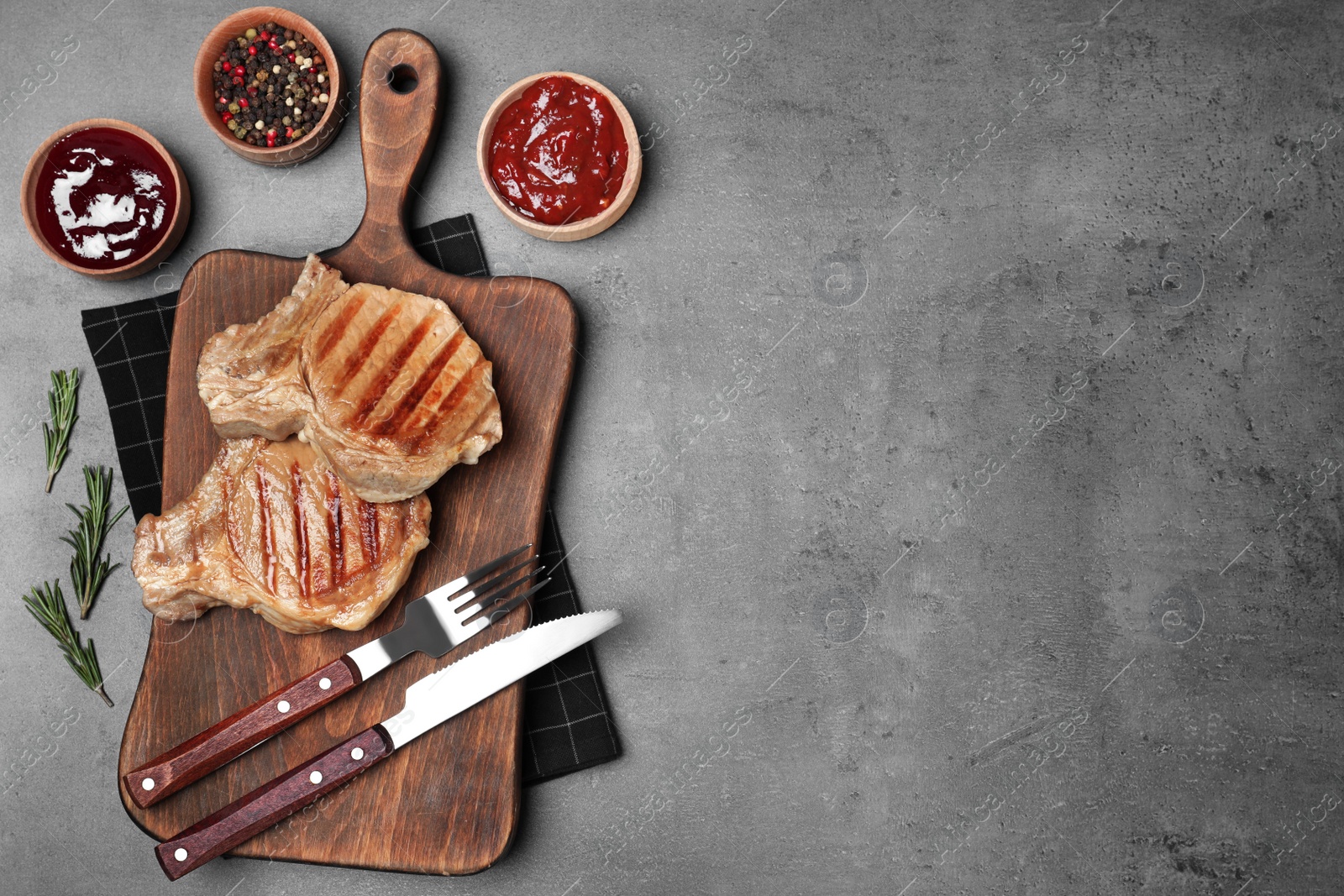 Photo of Flat lay composition with grilled meat on grey background. Space for text