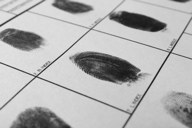 Photo of Police form with fingerprints, closeup. Forensic examination