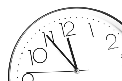 Photo of Clock showing five minutes until midnight on white background, closeup. New Year countdown