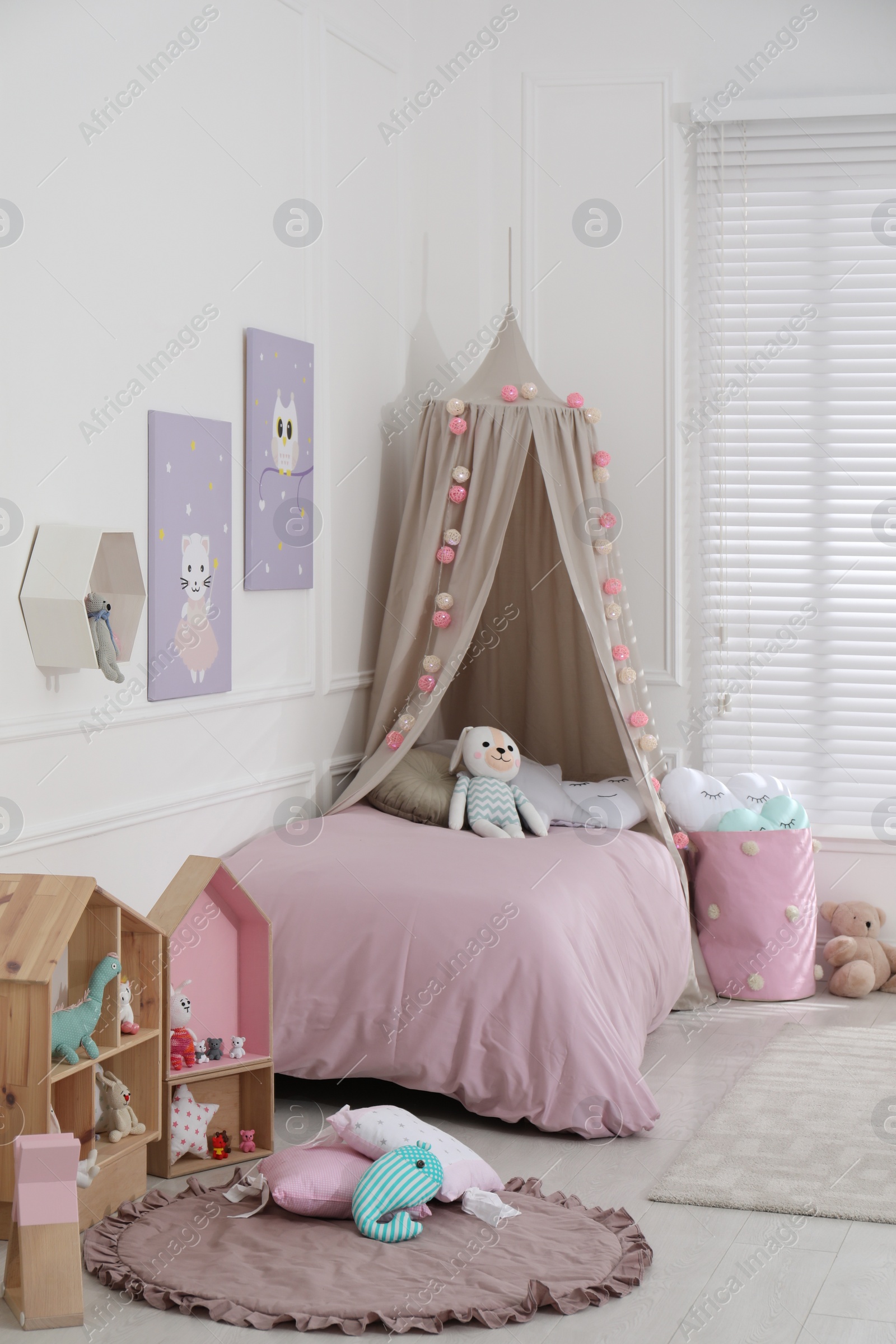 Photo of Cute child's room interior with toys and modern furniture