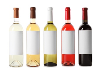 Photo of Bottles of delicious wines with blank labels on white background