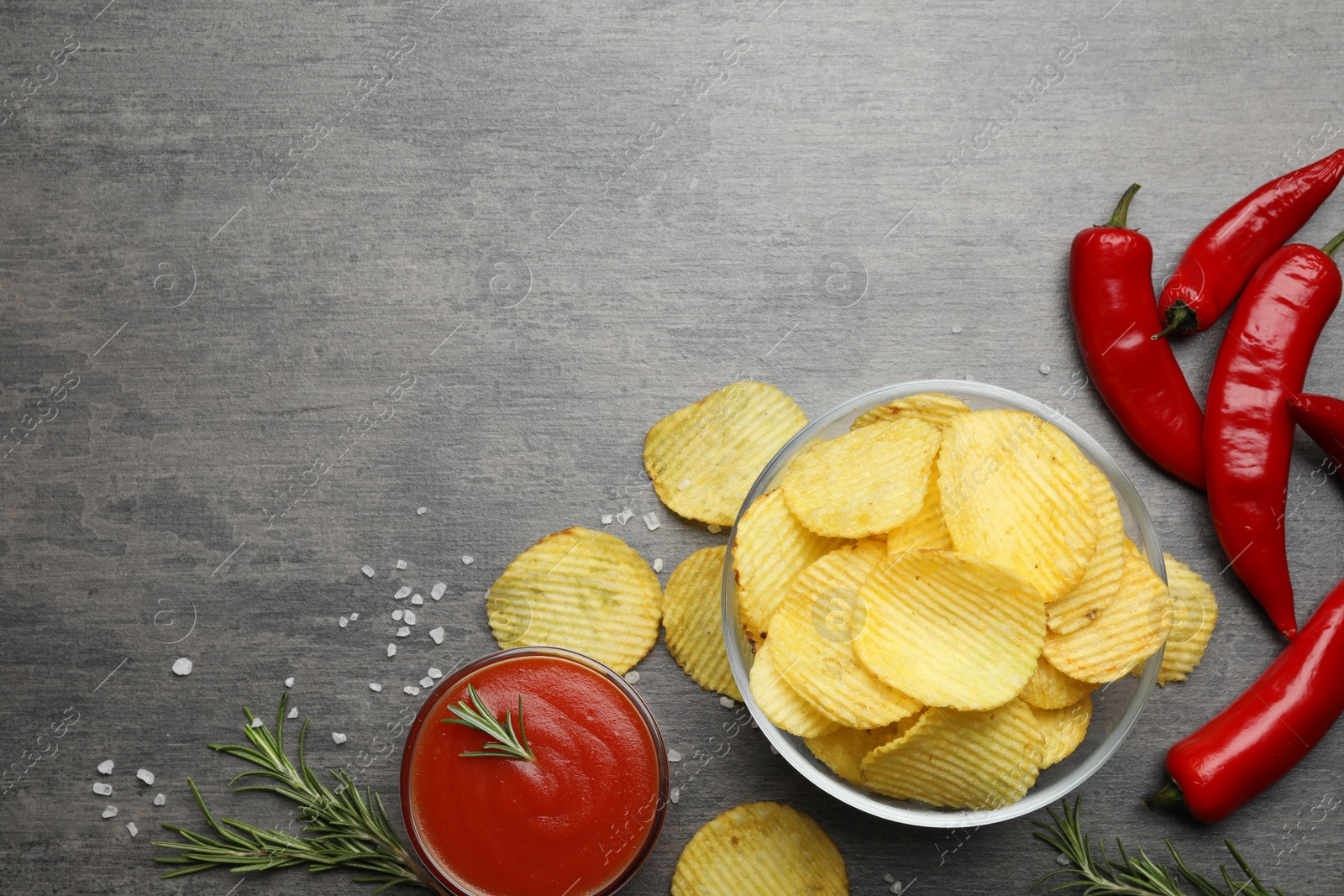 Photo of Flat lay composition with delicious crispy potato chips on table, space for text