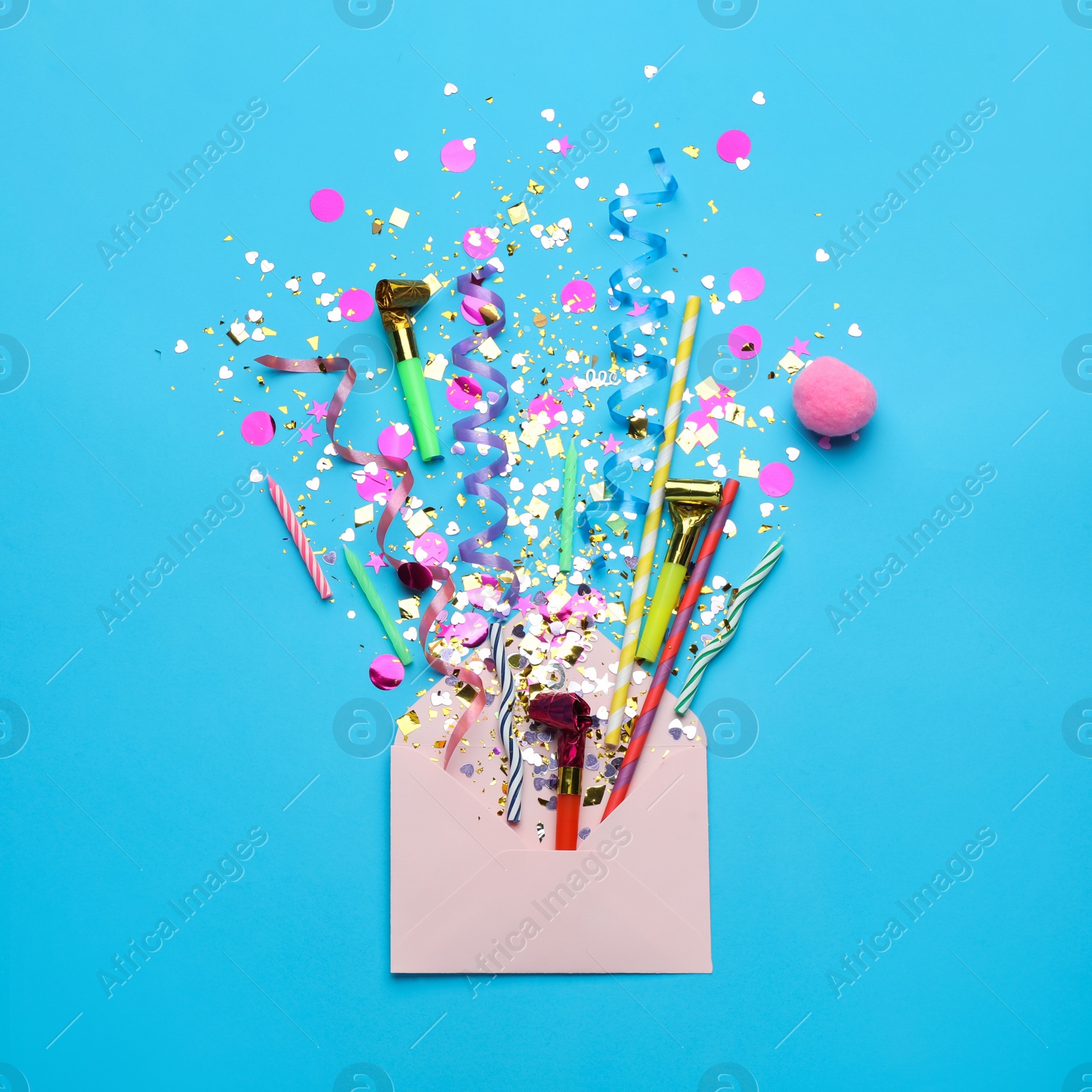 Photo of Beautiful flat lay composition with envelope and festive items on light blue background. Surprise party concept