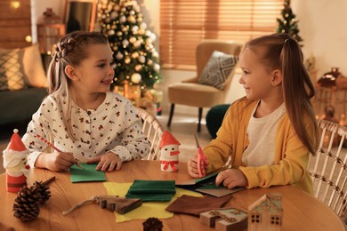 Photo of Cute children making Christmas greeting card at home