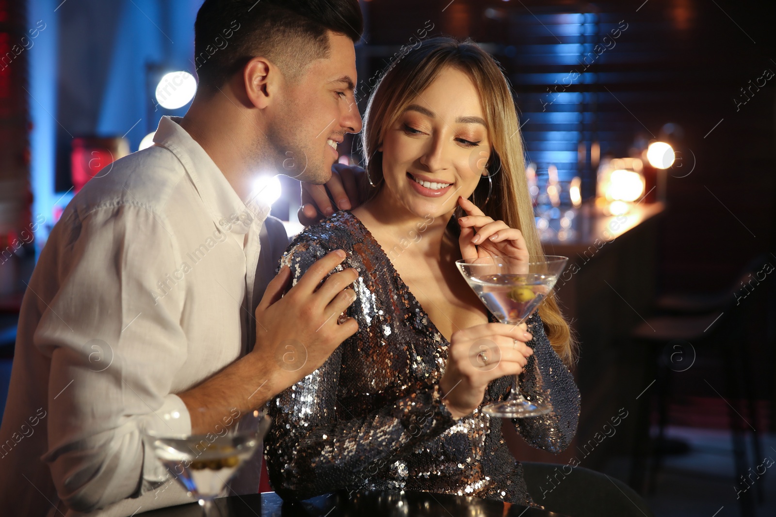 Photo of Man and woman flirting with each other in bar