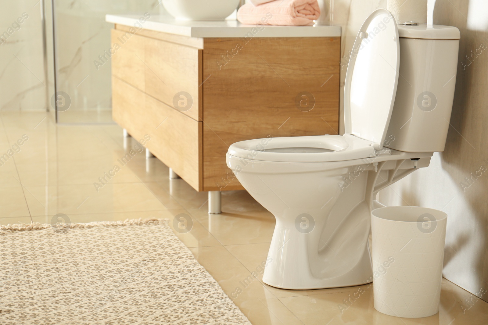 Photo of White toilet bowl in modern bathroom interior