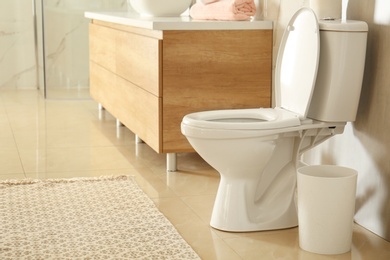 Photo of White toilet bowl in modern bathroom interior