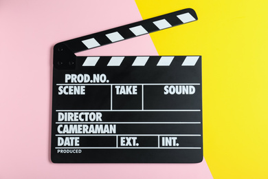 Photo of Clapper board on color background, top view. Cinema production