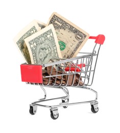 Photo of Small metal shopping cart with dollar bills and coins isolated on white