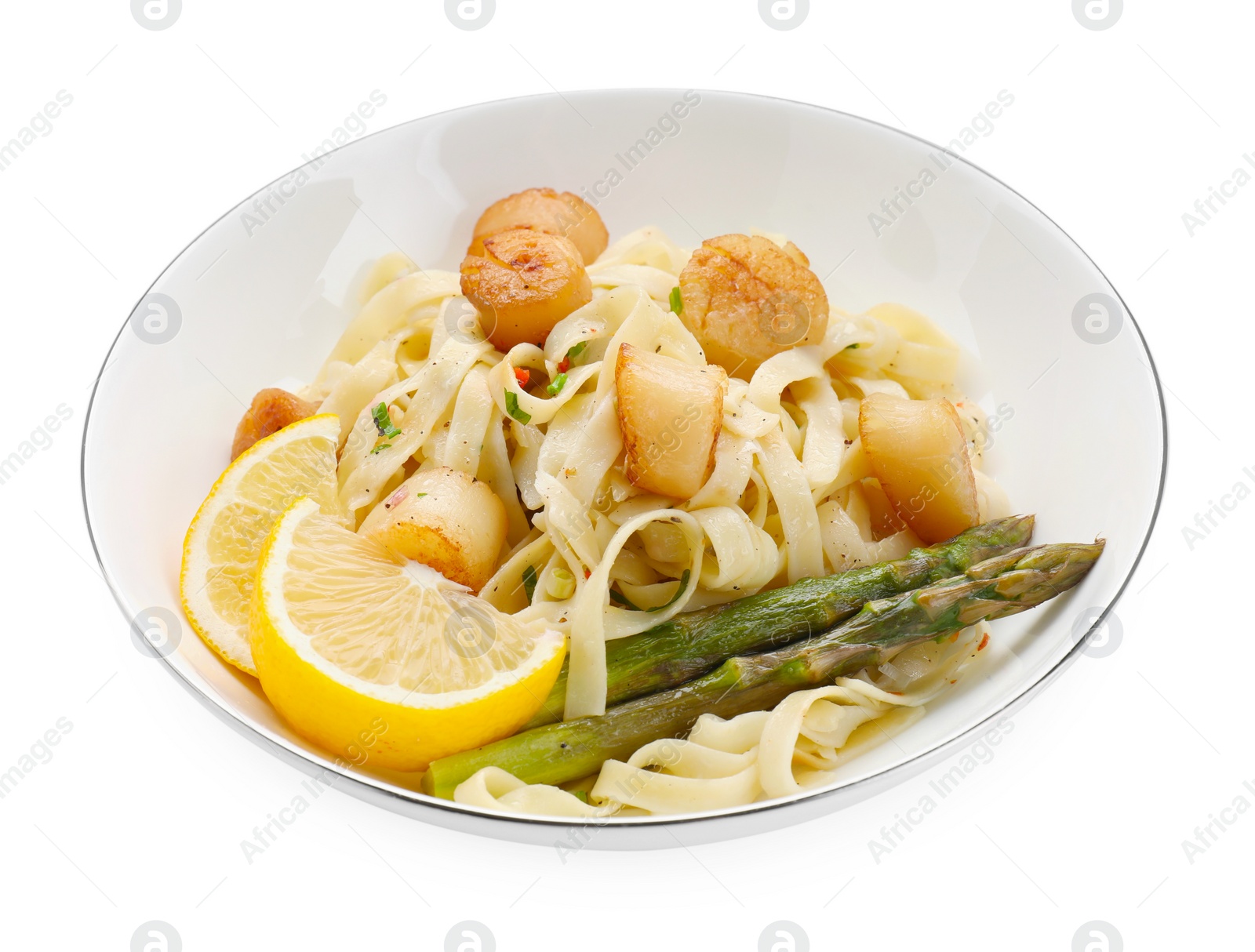 Photo of Delicious scallop pasta with asparagus and lemon isolated on white