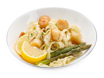 Photo of Delicious scallop pasta with asparagus and lemon isolated on white