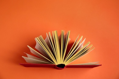 Photo of Hardcover book on orange background, top view