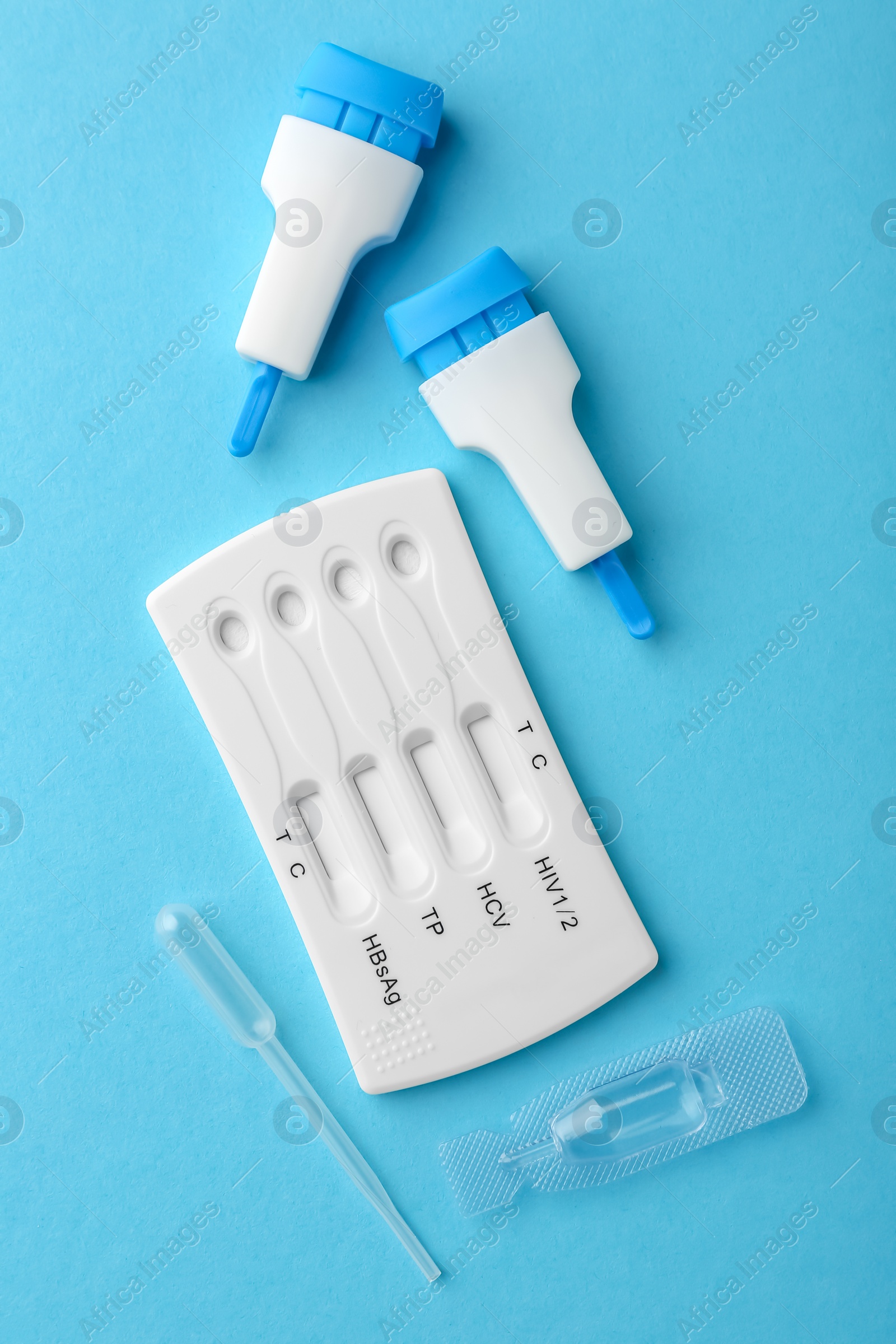 Photo of Disposable multi-infection express test kit on light blue background, flat lay