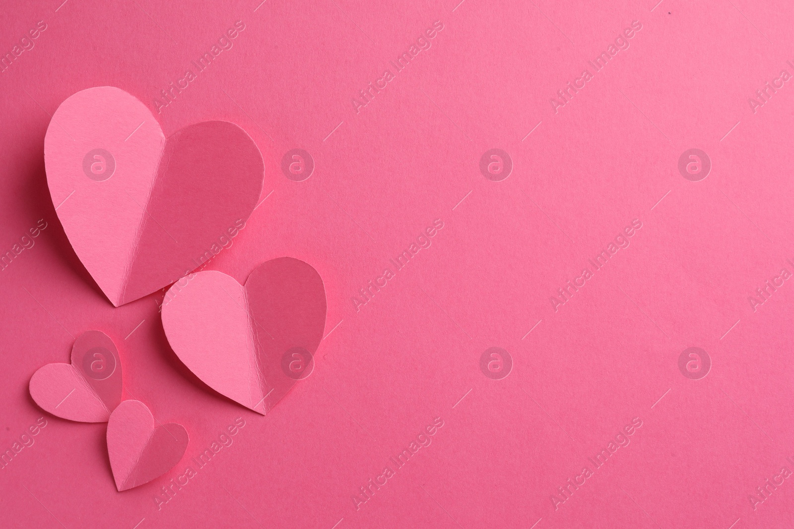 Photo of Paper hearts on pink background, flat lay. Space for text