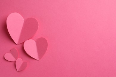 Photo of Paper hearts on pink background, flat lay. Space for text