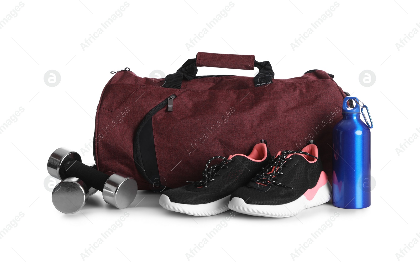 Photo of Sports bag and gym equipment on white background