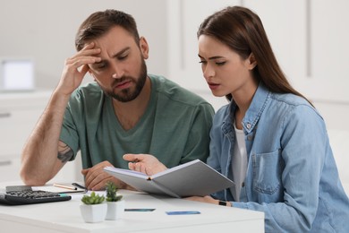 Young couple discussing family budget at home