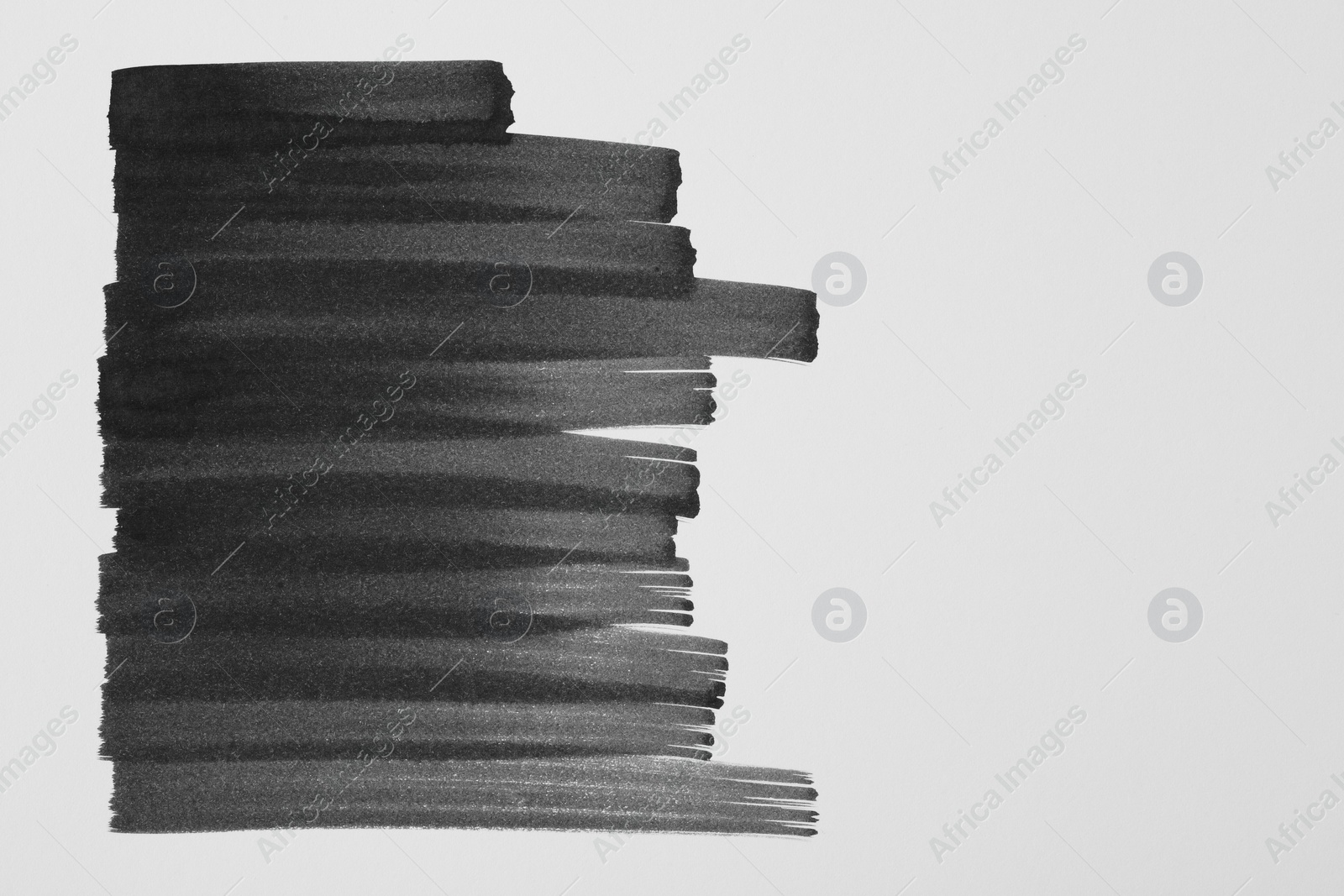 Photo of Strokes of black ink on white background, top view. Space for text