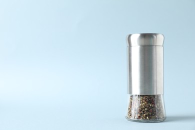 Photo of Pepper shaker on light background. Space for text