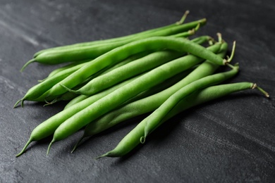 Fresh green beans on black table, closeup