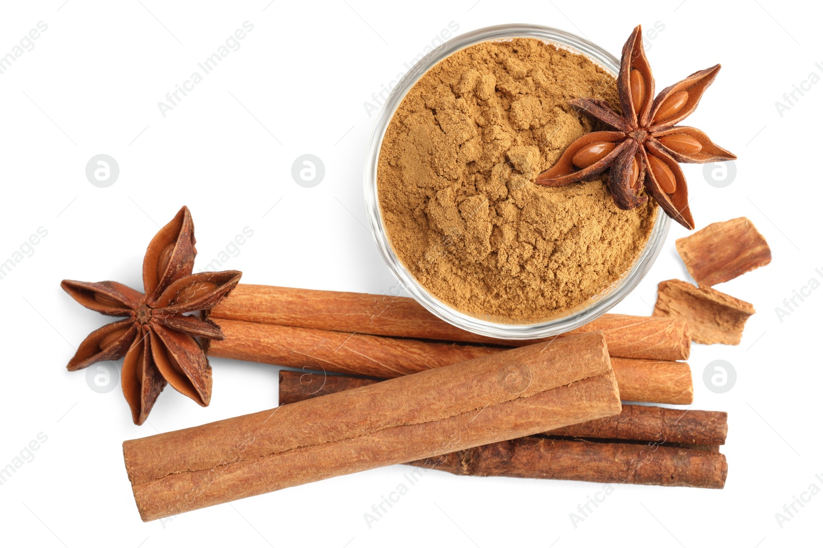 Photo of Dry aromatic cinnamon sticks, powder and anise stars isolated on white, top view