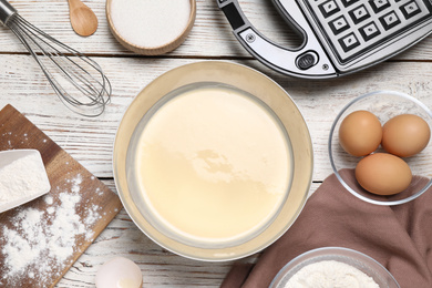 Photo of Flat lay composition with ingredients for cooking Belgian waffles on white wooden table