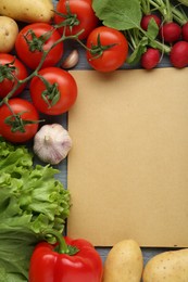 Photo of Blank recipe book and different ingredients on grey wooden table, flat lay. Space for text