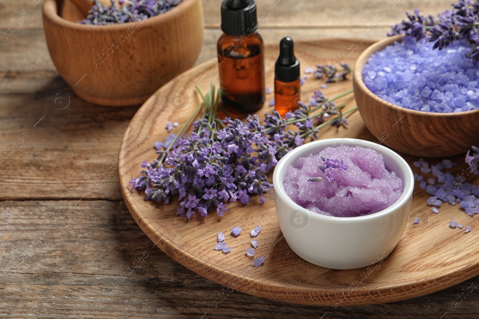 Photo of Plate with natural cosmetic products and lavender flowers on wooden table