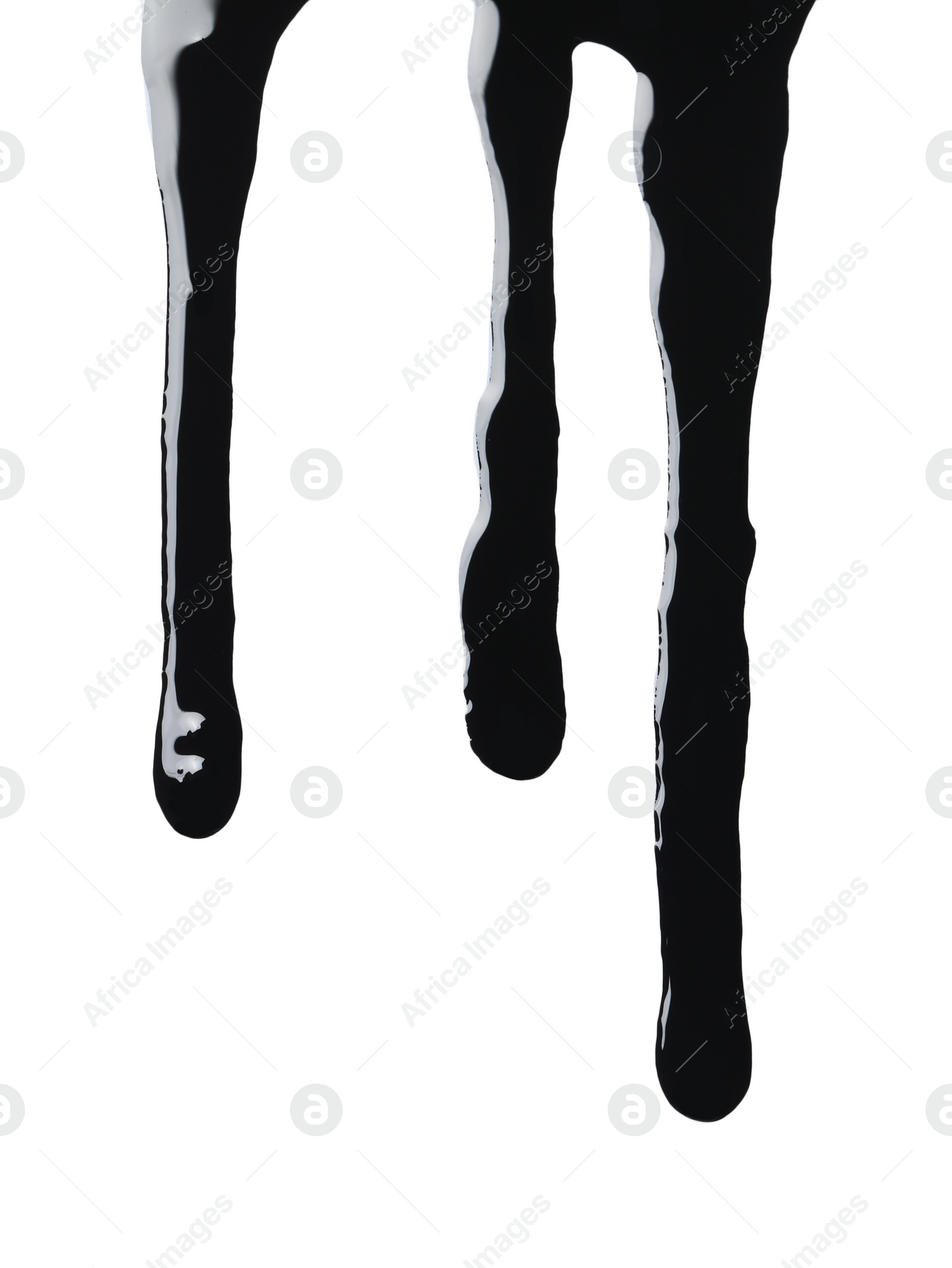 Photo of Black glossy oil flowing on white background