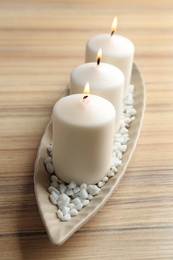 Composition with three candles on wooden table