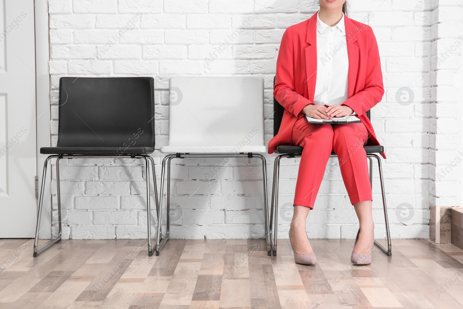 Photo of Young woman waiting for job interview, indoors