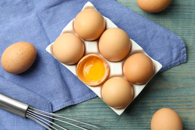 Photo of Flat lay composition with chicken eggs on blue wooden table