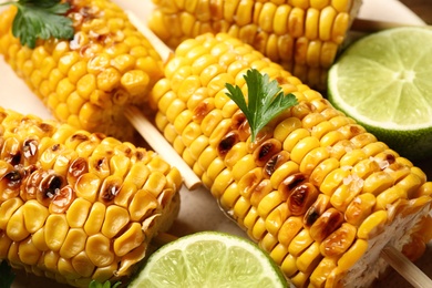 Photo of Tasty grilled corn and lime, closeup view