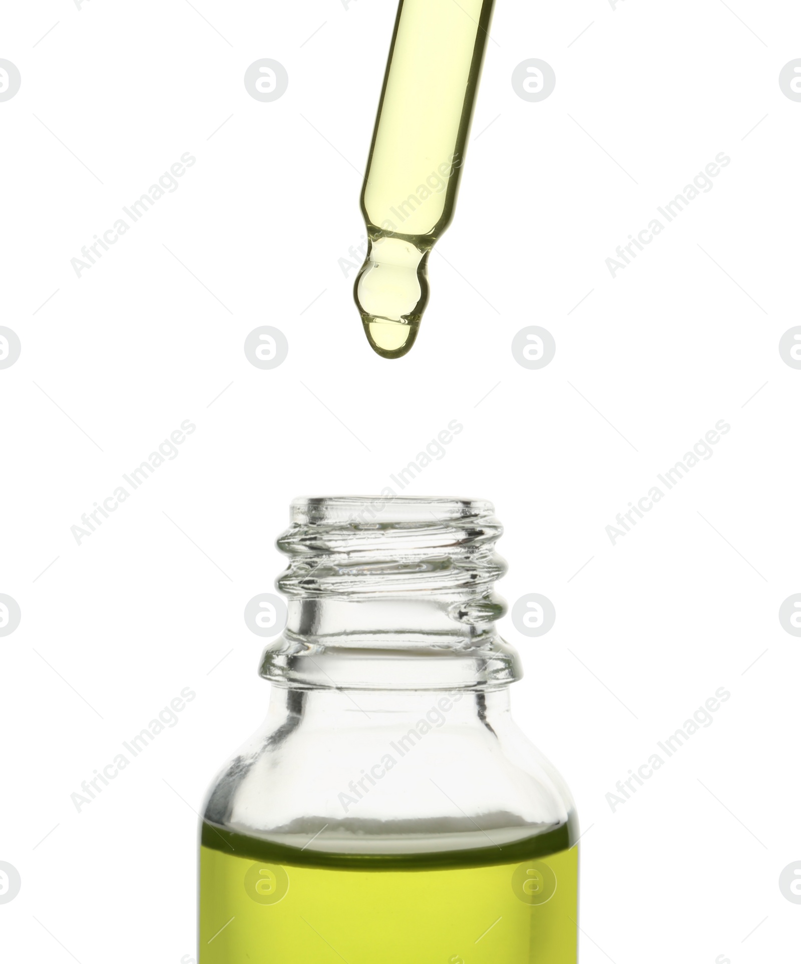 Photo of Dripping oil from pipette into glass bottle isolated on white, closeup