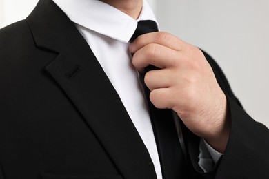 Businessman in suit and necktie indoors, closeup